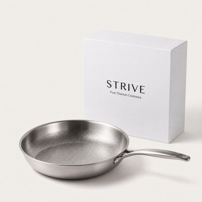 The Strive titanium pan next to its gift box